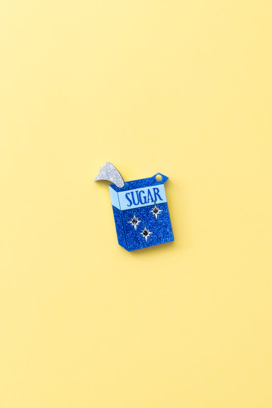 Charm de metacrilato inspirado en el azucar de las supernenas, azul y blanco con purpurina brillante