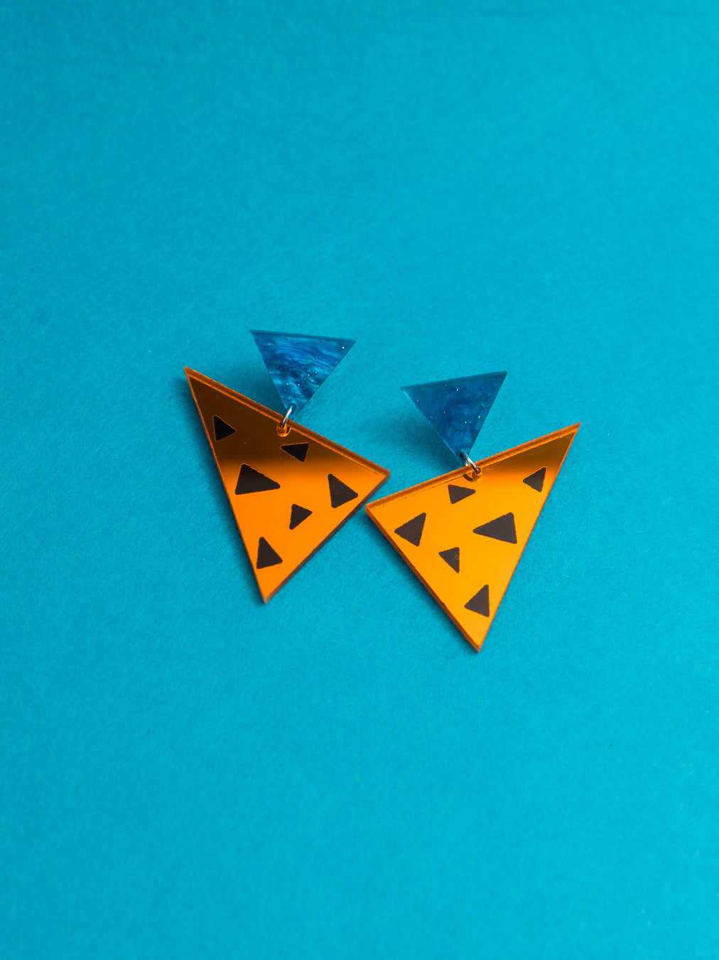 Pendientes de metacrilato inspirados en la vestimenta de Pedro Picapiedra. Con efectos espejo y aguas y un  estilo animal print