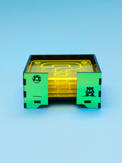 Posavasos de metacrilato inspirados en mario bros, los posavasos son amarillo fluor con su gotas antideslizantes y la caja en metacrilato espejo iridiscente 