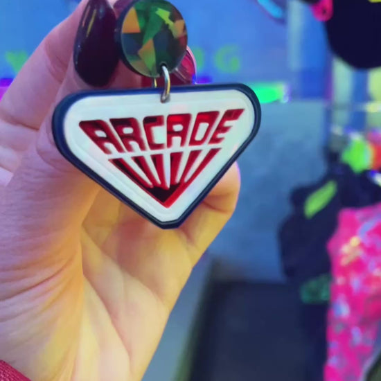 Pendientes de botón inspirados en las recreativas de Stranger Things, hechos con metacrilato de efecto prisma y espejo naranja.